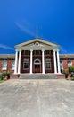 Classic Red Brick Building With Greek White Column Entrance