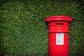 Classic Red British Pillar Box Against Hedge Royalty Free Stock Photo