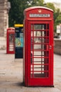 Classic red British telephone box in London with blurred background on hot sunny summer day Royalty Free Stock Photo