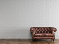 Classic red brown leather armchair standing in front of white brick wall with copy space Royalty Free Stock Photo