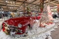 Classic red car with fake snow and Christmas decorations at a museum
