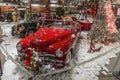 Classic red car with fake snow and Christmas decorations at a museum