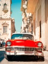 Classic red car on a narrow street in Old Havana Royalty Free Stock Photo