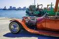 Classic red car Parked near a large transport ship At the Port of Pattaya, Thailand Royalty Free Stock Photo