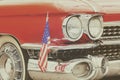 Classic red front of an old car with the American flag Royalty Free Stock Photo