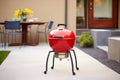 classic red kettle grill on a concrete patio Royalty Free Stock Photo