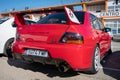 Classic red Mitsubishi Lancer Evolution IX parked at an exhibit