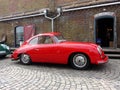 Classic red Porsche 356 Coupe parked on a cobblestone road Royalty Free Stock Photo
