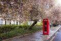 A classic, red telephone booth on a street in London Royalty Free Stock Photo