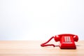 Classic red telephone on wooden desk Royalty Free Stock Photo