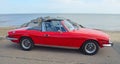 Classic Red Triumph Stag Motor Car Parked on Seafront Promenade.