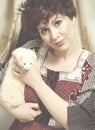 Classic retro style fashion portrait of young pin-up girl holding white weasel pet. American style.