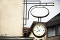 Classic retro vintage metal clock hanging on front of building Royalty Free Stock Photo