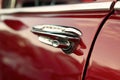 Classic retro vintage red car. Car door handle. The car is older than 1985 Royalty Free Stock Photo