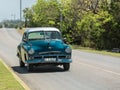 classic, retro vintage taxi car driving on the road in Cuba