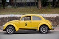 Classic retro yellow car Volkswagen Beetle on the road Royalty Free Stock Photo