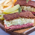 Classic reuben sandwich, served with dill pickle, potato chips, square Royalty Free Stock Photo