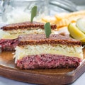 Classic reuben sandwich, served with dill pickle, potato chips, square format Royalty Free Stock Photo