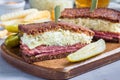 Classic reuben sandwich, served with dill pickle, potato chips, horizontal Royalty Free Stock Photo