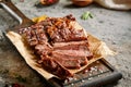 Classic ribeye steak served in waxed paper on wooden cutting board