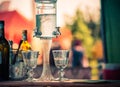 Ritual of glass of absinthe and dripping fountain