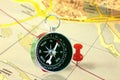 Classic round compass on old paper map