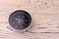 Classic round compass on white wooden vintage background. Travel concept. Copy space. Royalty Free Stock Photo