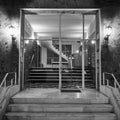 A classic 60s luxury residential apartments building entrance night capture in black and white. Royalty Free Stock Photo