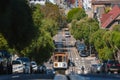 Classic San Francisco cable car on steep hill, sunny day
