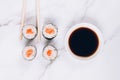 Classic sashimi with salmon fish, soy sauce and chopsticks on white marble table background - maki sushi roll, nori maki