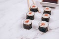 Classic sashimi with salmon or tuna fish, soy sauce and chopsticks on white marble table background - maki sushi roll