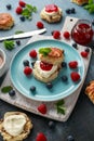 Classic scones with clotted cream, strawberries jam, english Tea and other fruit Royalty Free Stock Photo