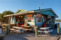 classic seafood shack, with picnic tables and paper plates, serving crab legs and scallops