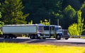 Classic semi truck big rig with two trailers on highway