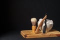 Classic Shaving Equipment With Razor, Brush, and Soap on Wooden Stand Against Dark Background Royalty Free Stock Photo