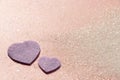Classic shiny pastel pink glitter background with purple hearts Royalty Free Stock Photo