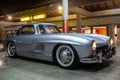 Classic silver sports car parked in a lot