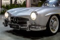 Classic silver sports car parked in a lot