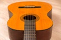 Classic six-string acoustic guitar on a wooden base. Selective focus Royalty Free Stock Photo