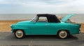 Classic Skoda Felicia Convertible parked on seafront promenade beach and sea in the background.