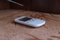 Classic smartphone with full QWERTY keyboard on the sofa