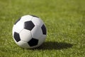 Classic soccer football ball on a grass pitch. Side view on retro classic football ball Royalty Free Stock Photo