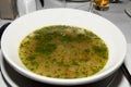 Classic Soup au pistou pesto in a white bowl being served in a restaurant. traditional authentic Royalty Free Stock Photo