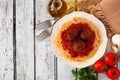 Spaghetti and meatballs with tomato sauce, top view corner border on a white wood background Royalty Free Stock Photo