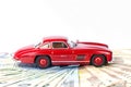 A classic sports car of the year 1954 of red color over euro bills Royalty Free Stock Photo