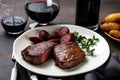 classic steak and potatoes dinner, served on white plate with red wine