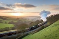 classic steam train chugging through the countryside, with rolling hills and pastel skies Royalty Free Stock Photo