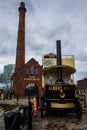 A classic steam truck against a classic building at the Liverpool Docks, Port of Liverpool, late on a cloudy afternoon