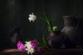 Classic still life with beautiful white tulip flower in vintage clay jar and cut white and pink tulips bouquet lying on the table Royalty Free Stock Photo