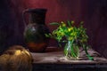 Classic still life with bouquet of spring yellow flowers Gagea, old vintage jug and yellow drapery in a ray of light on brown